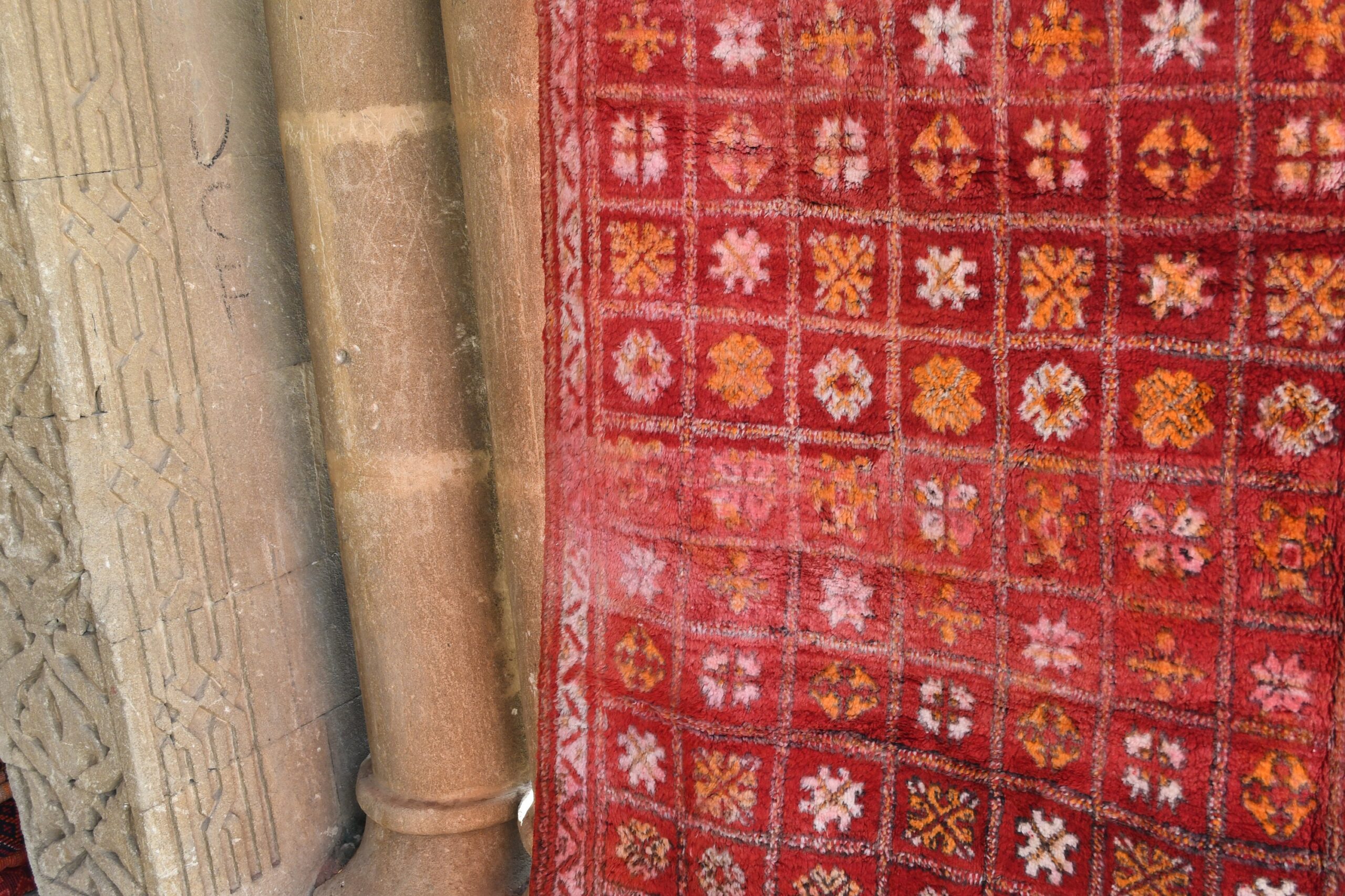 a red rug with a white cat sitting on it. il_fullxfull.6076156195_bzj0.jpg