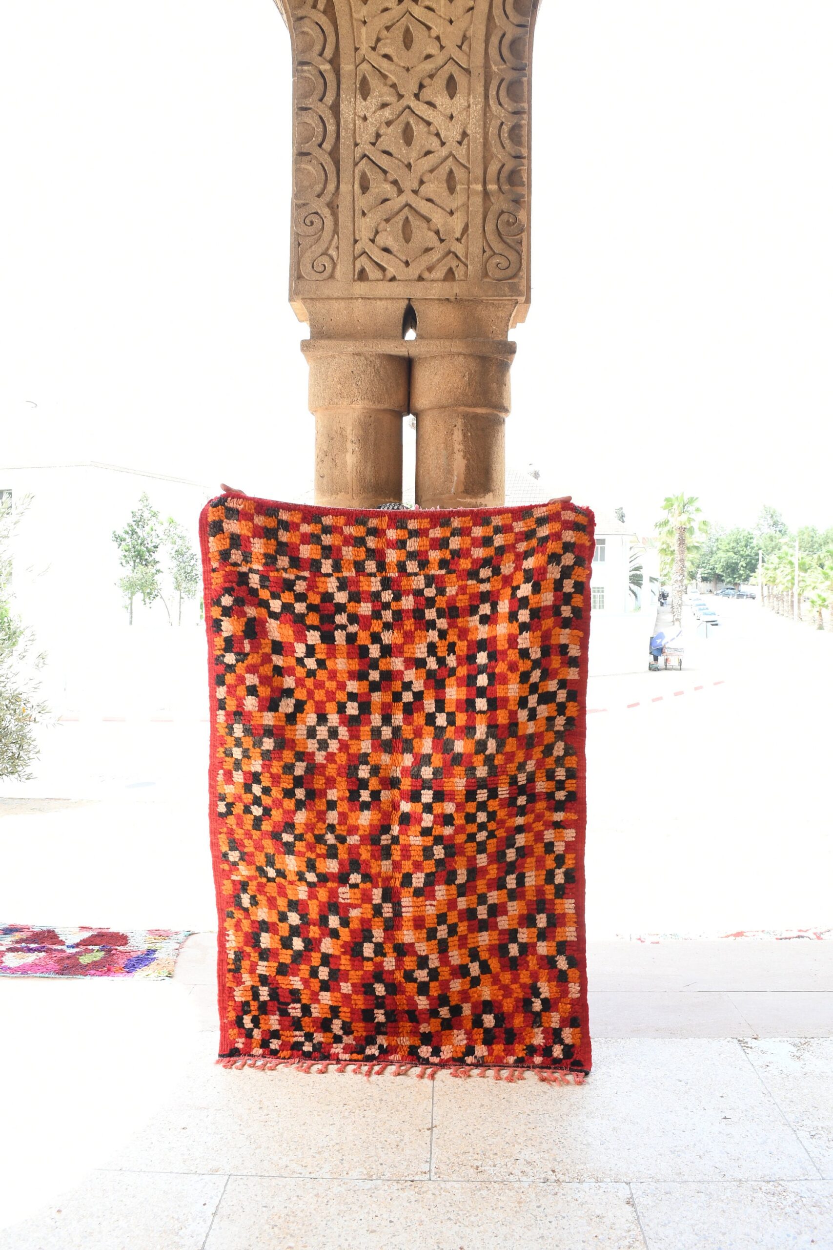 a red and black moroccan rug on a stone pillar. il_fullxfull.6076158197_1vcy.jpg