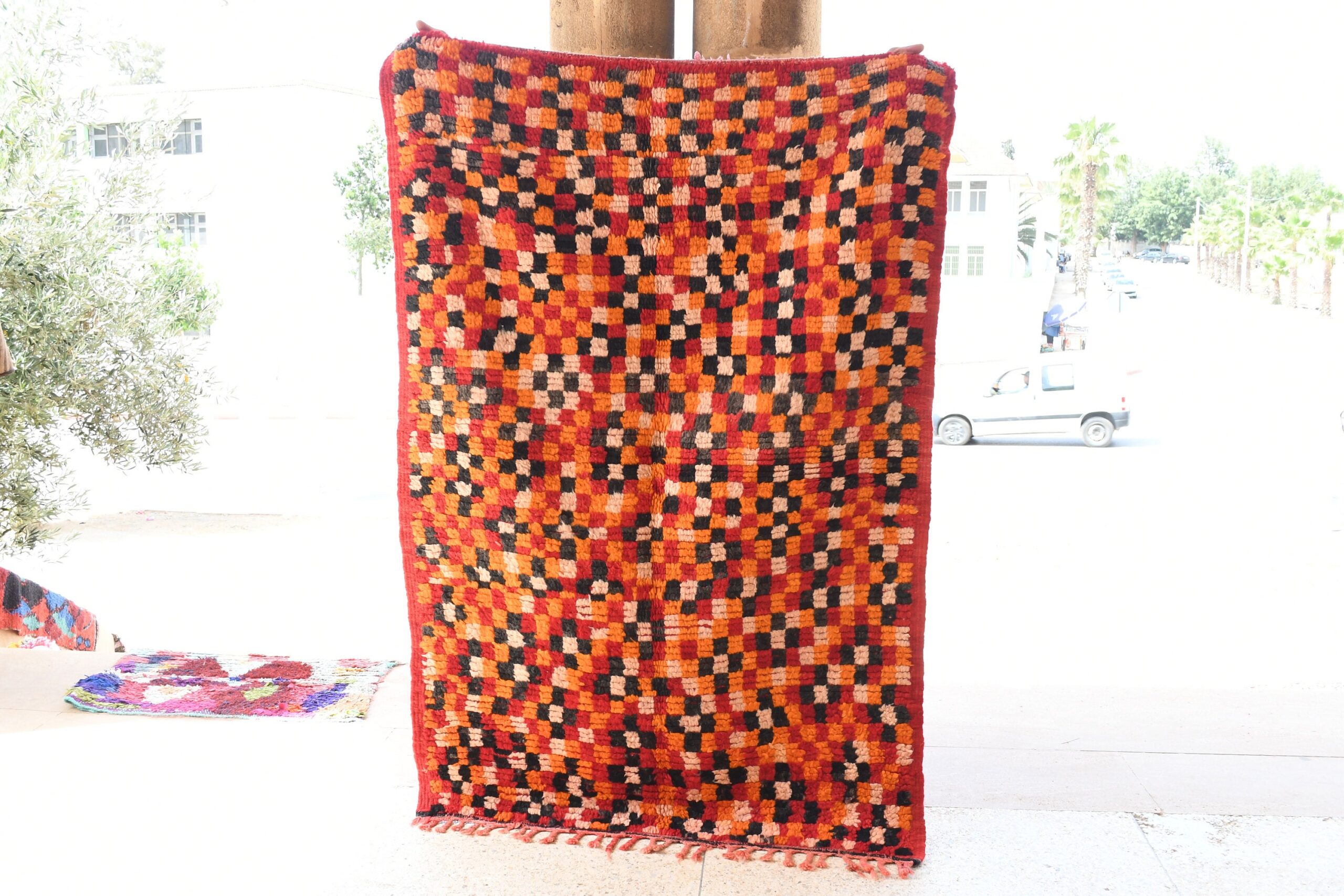 a red and black quilt hanging on a pole. il_fullxfull.6076158609_e1gv.jpg