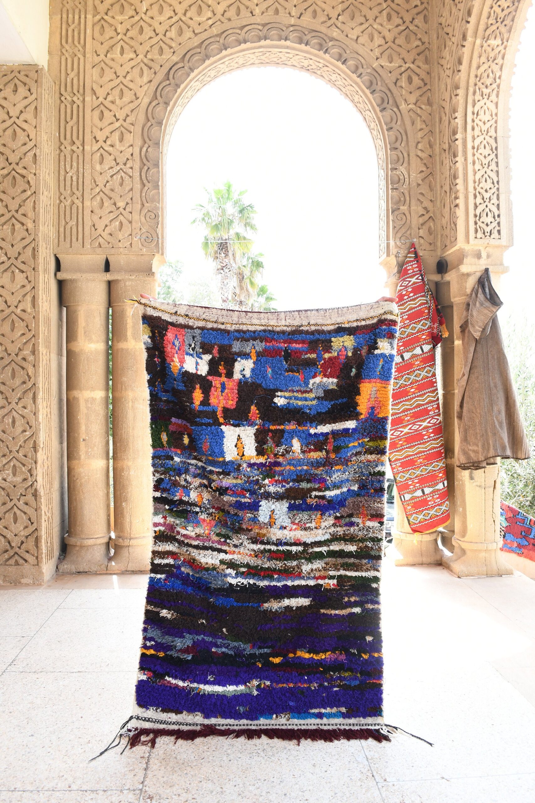 a colorful rug hanging in a room. il_fullxfull.6076162963_6yer.jpg