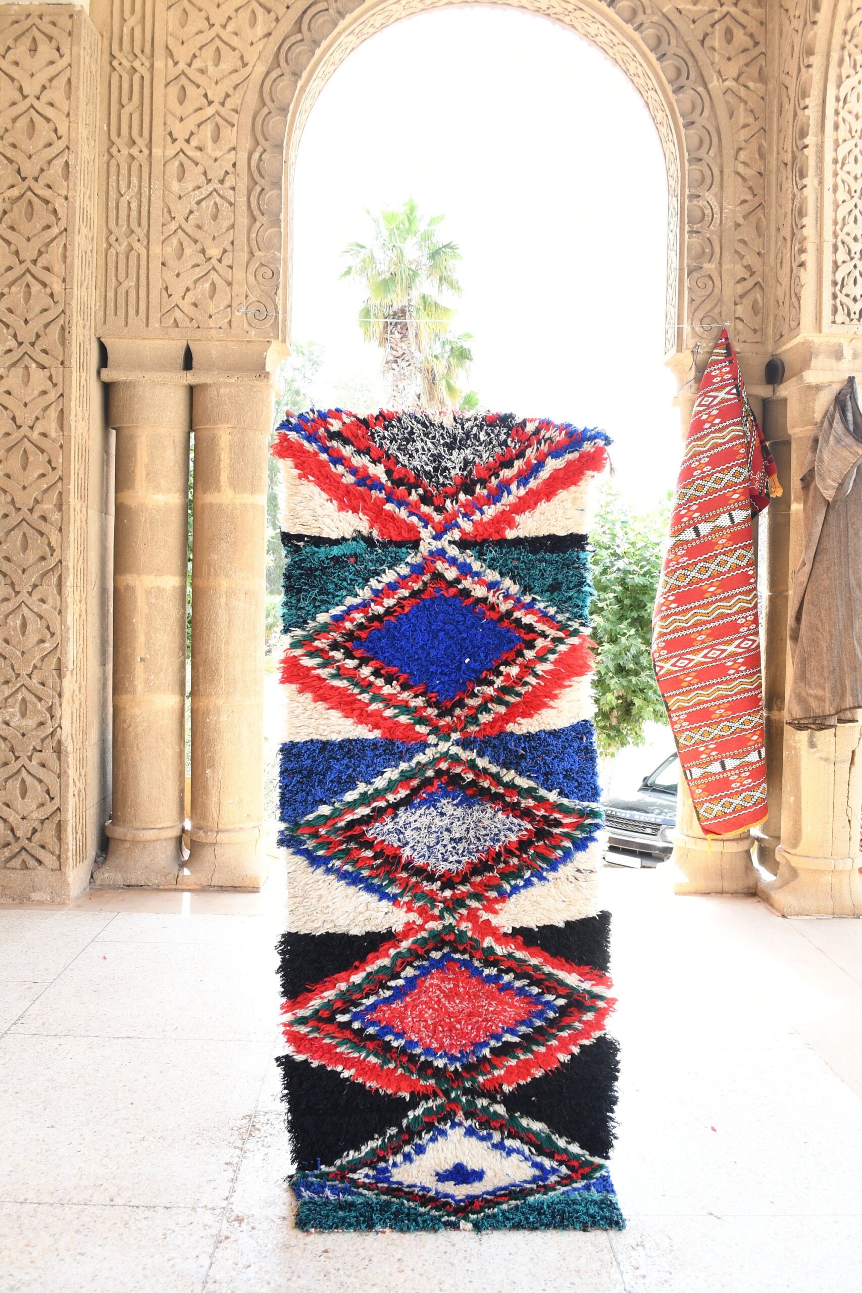 a colorful rug is displayed in the entrance to the palace. il_fullxfull.6076168805_p1nm.jpg