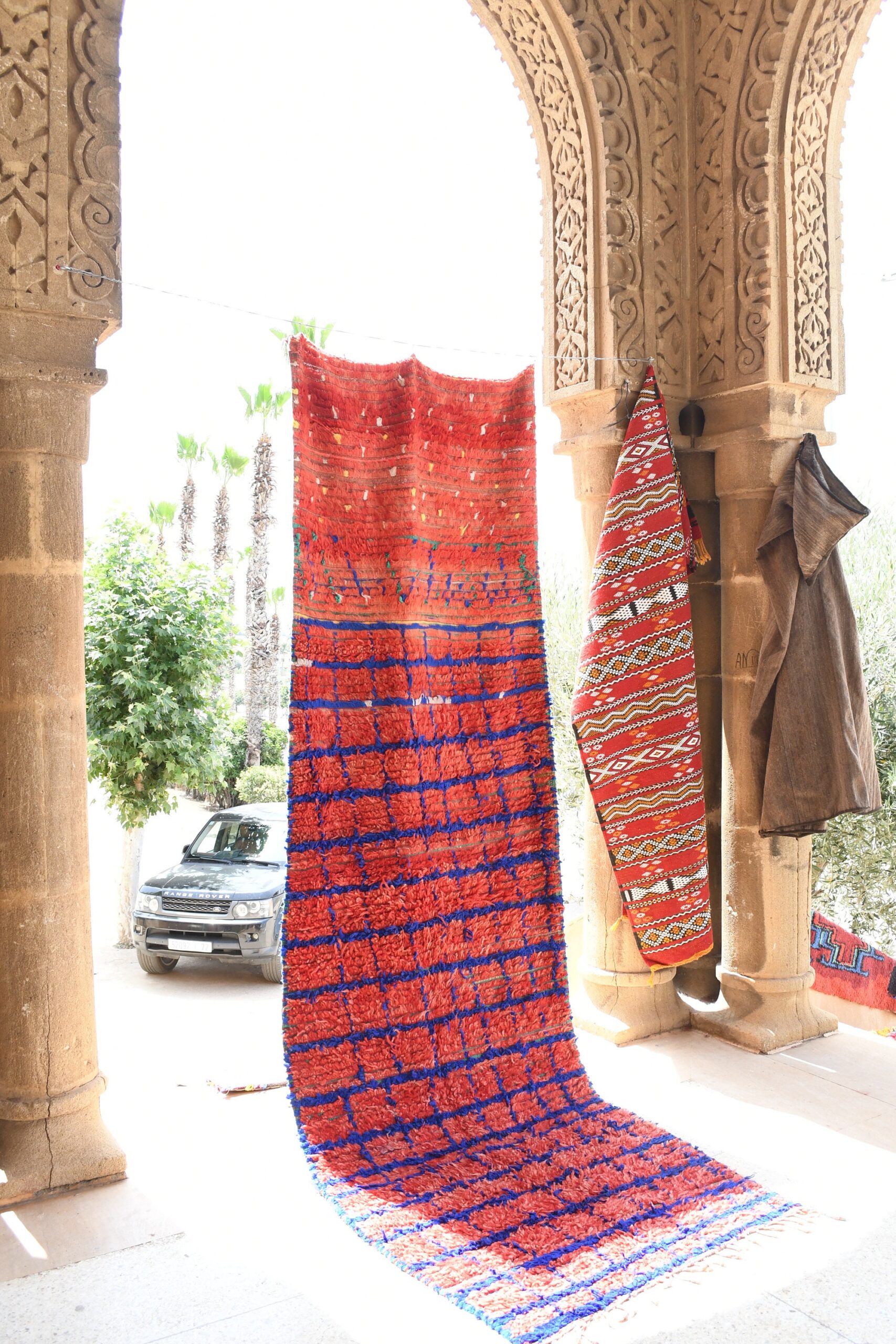 a colorful rug is hanging on a wall. il_fullxfull.6076178551_seyg.jpg