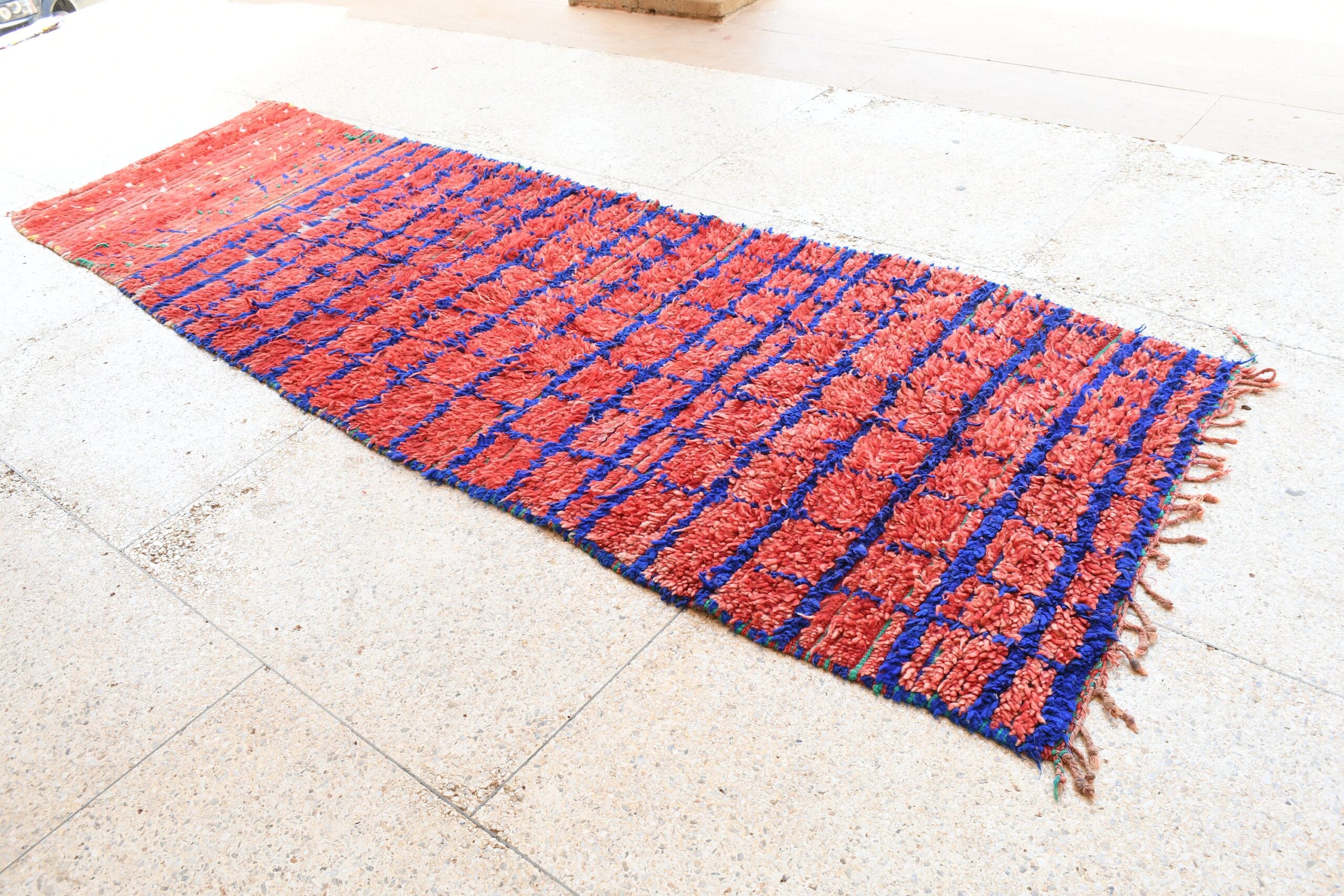 a red and blue rug on the floor. il_fullxfull.6076178697_eg3p.jpg
