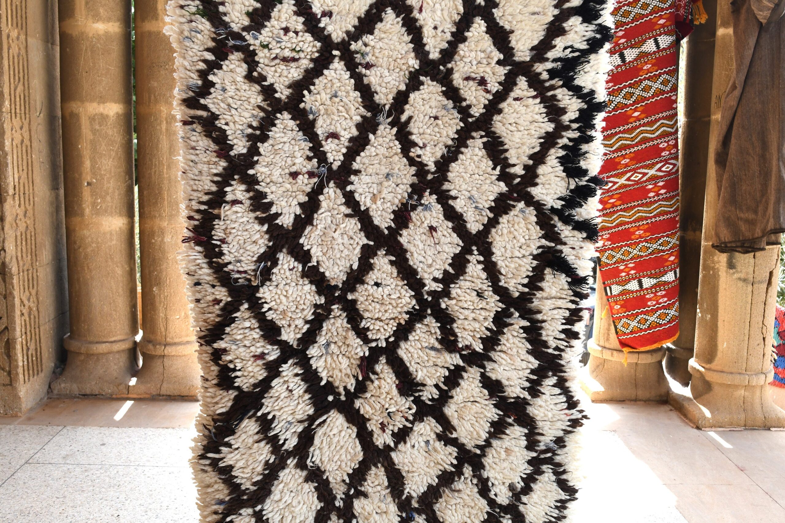 a rug is hanging on a wall. il_fullxfull.6076181329_lhxo.jpg