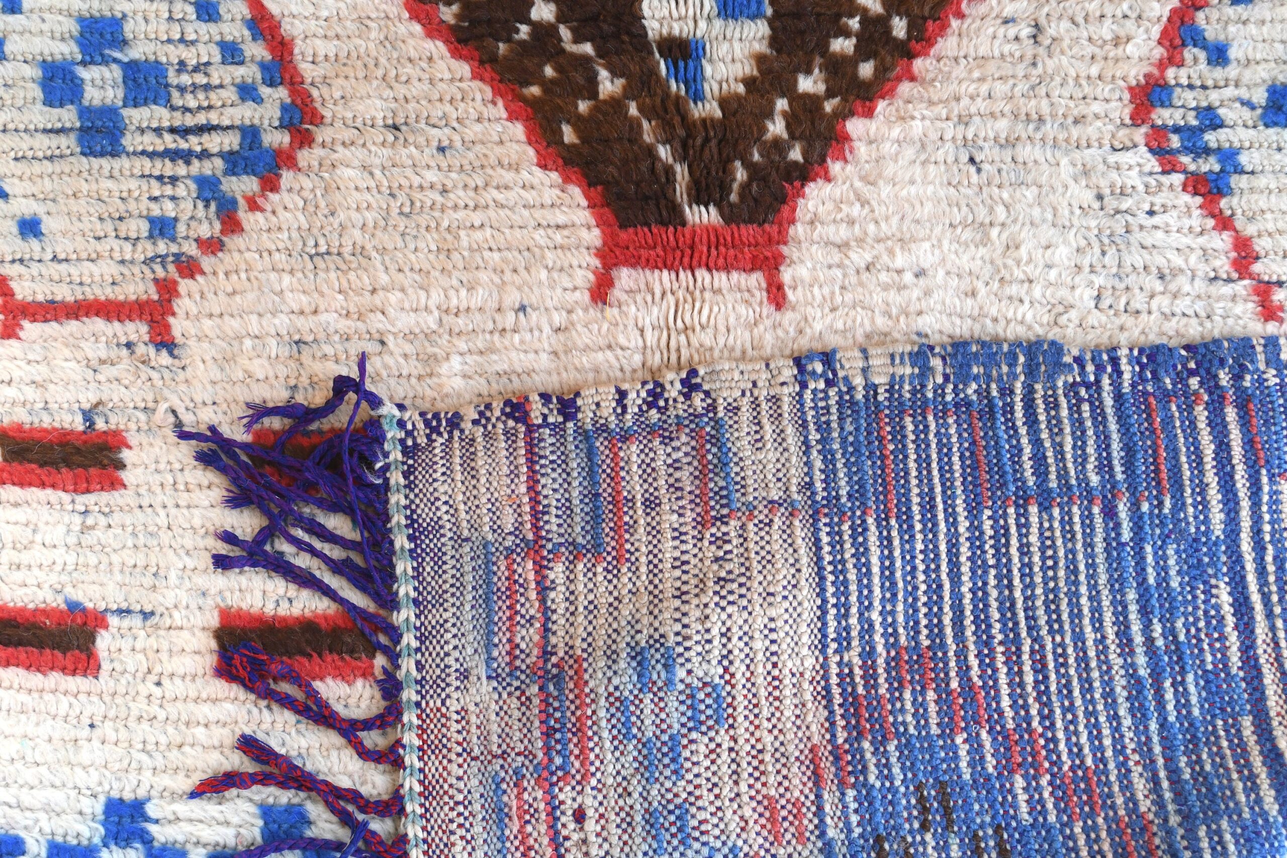a rug with a blue and red design. il_fullxfull.6076192689_50zb.jpg