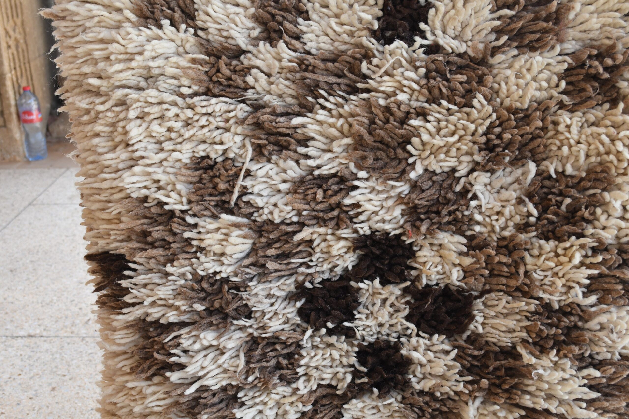 a pile of brown and white rugs. il_fullxfull.6076270623_bgvt.jpg