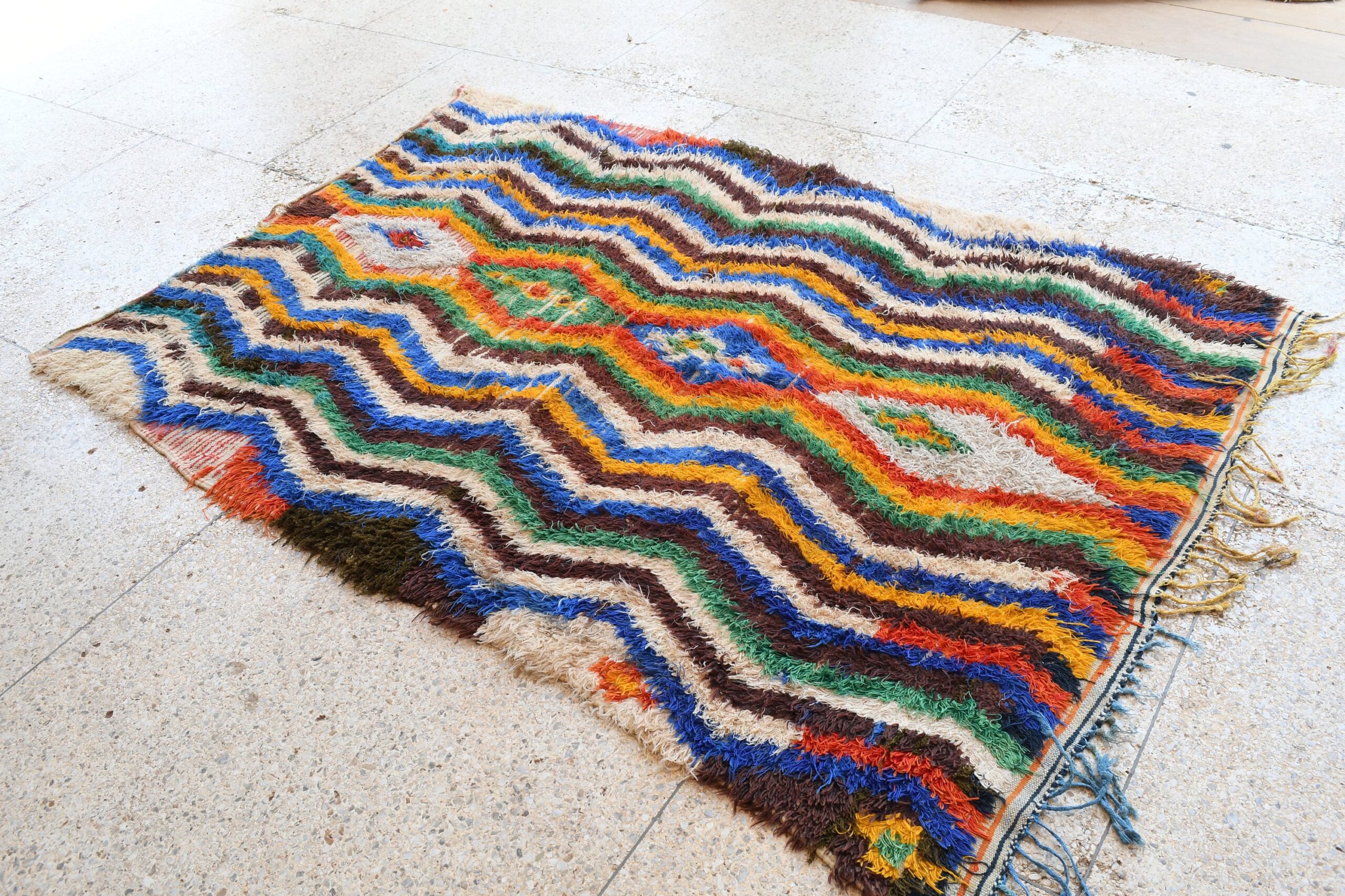a colorful rug with a large, wavy pattern. il_fullxfull.6076274385_5qw1.jpg