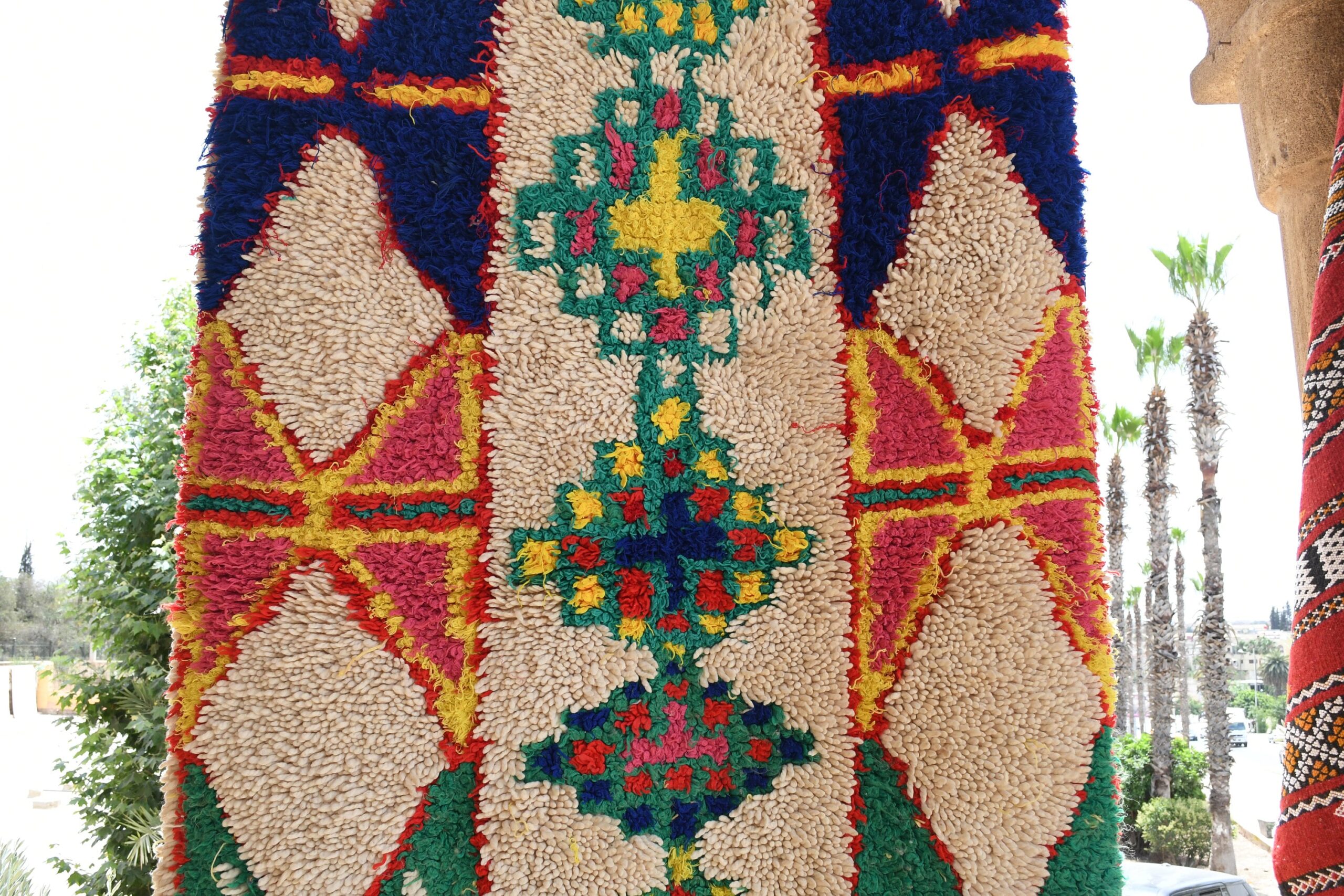 a colorful rug hanging on a wall. il_fullxfull.6076275523_bqad.jpg