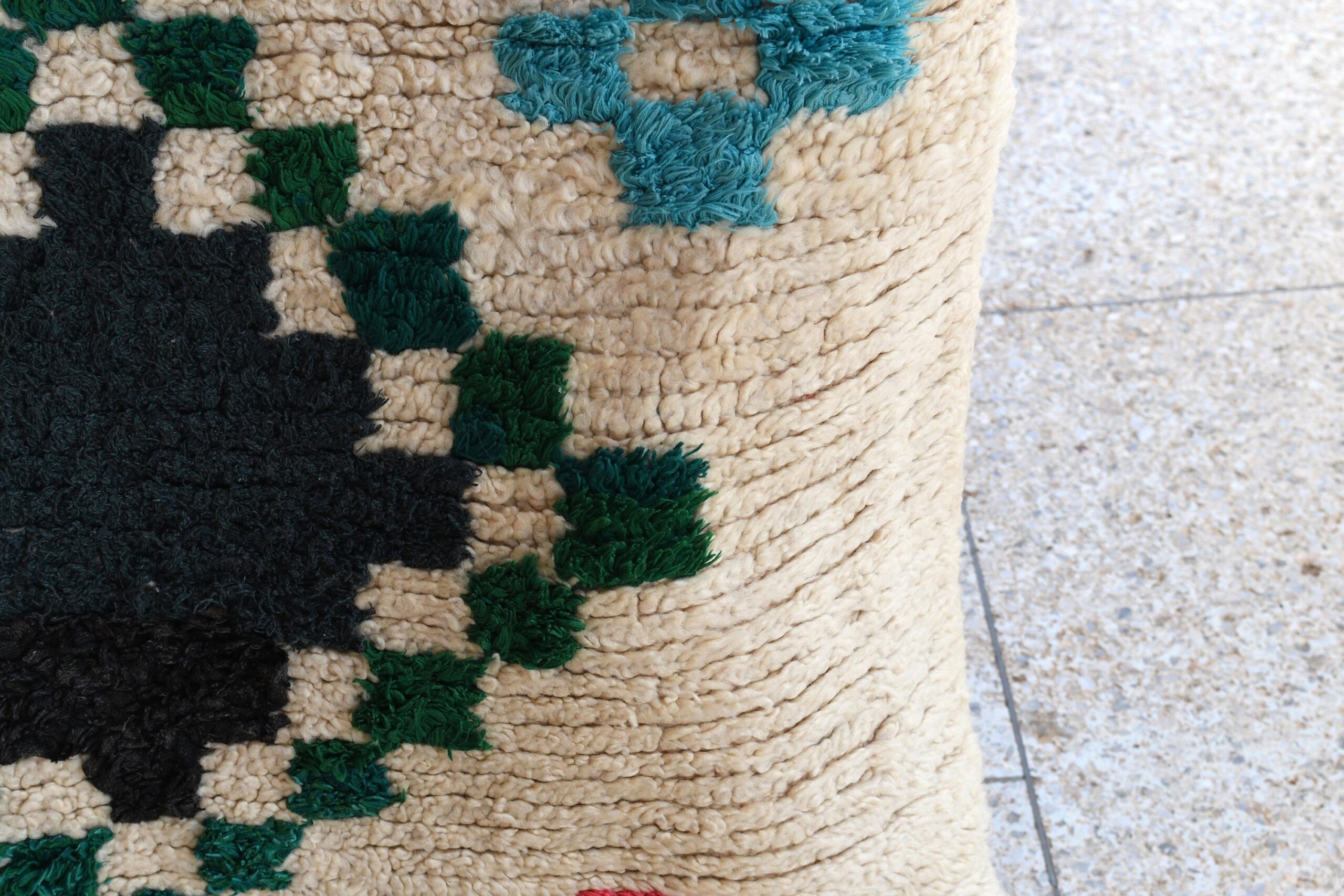 a stuffed bear is sitting on a rug. il_fullxfull.6076303601_lwbw.jpg