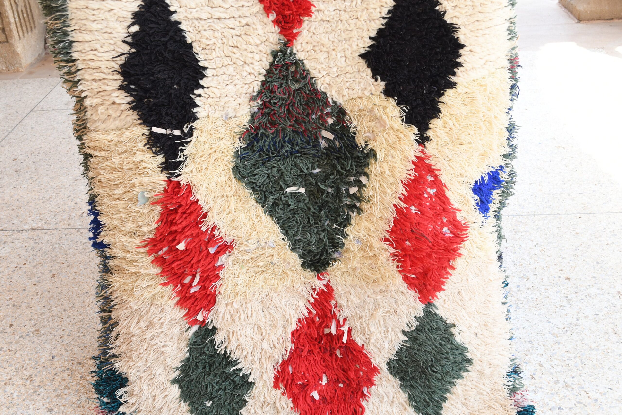 a large pile of rugs on a sidewalk. il_fullxfull.6076305359_dhlk.jpg