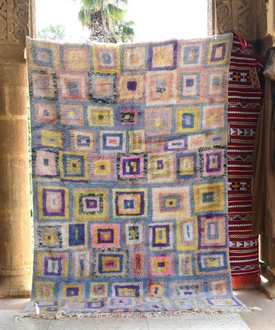 a colorful rug is hanging on a wall. il_fullxfull.6083090093_owqk.jpg