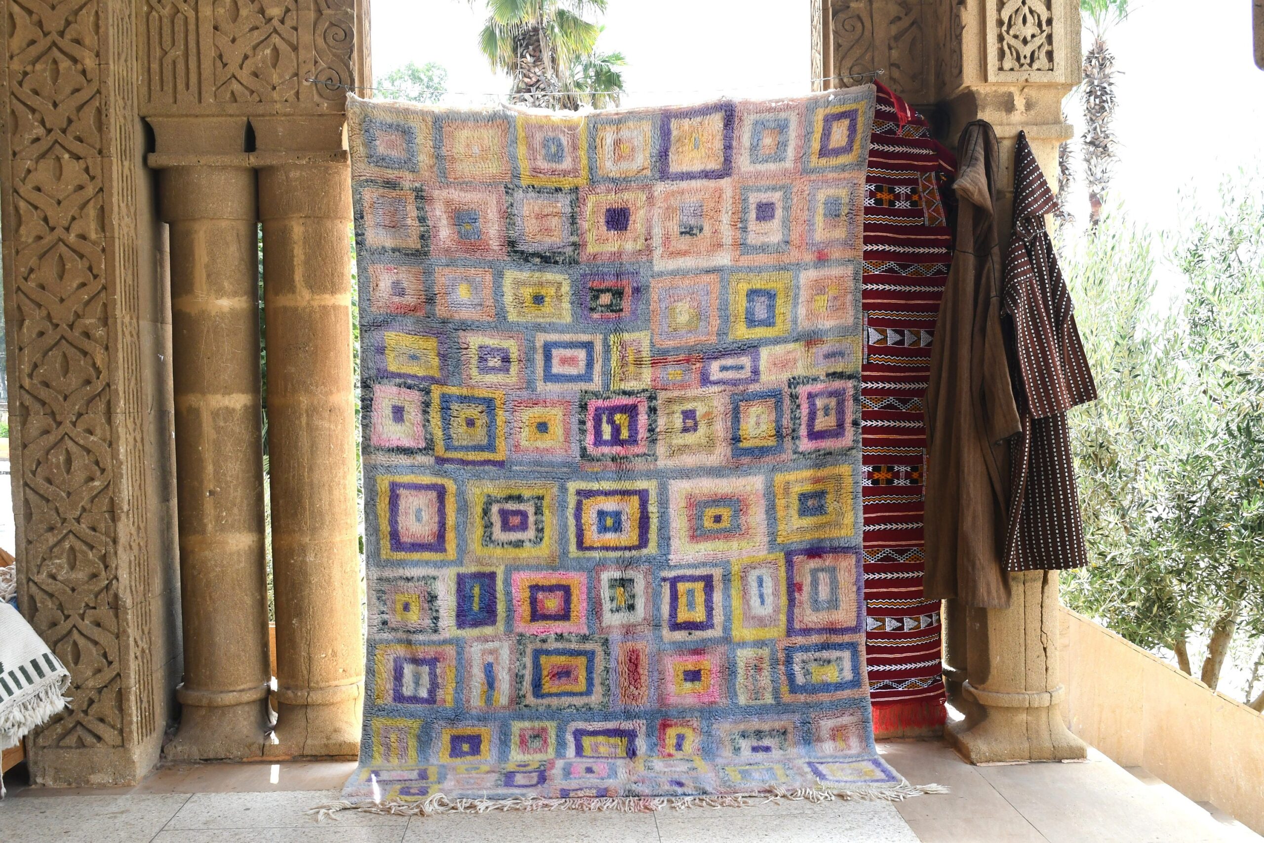 a colorful rug is hanging on a wall. il_fullxfull.6083090093_owqk.jpg