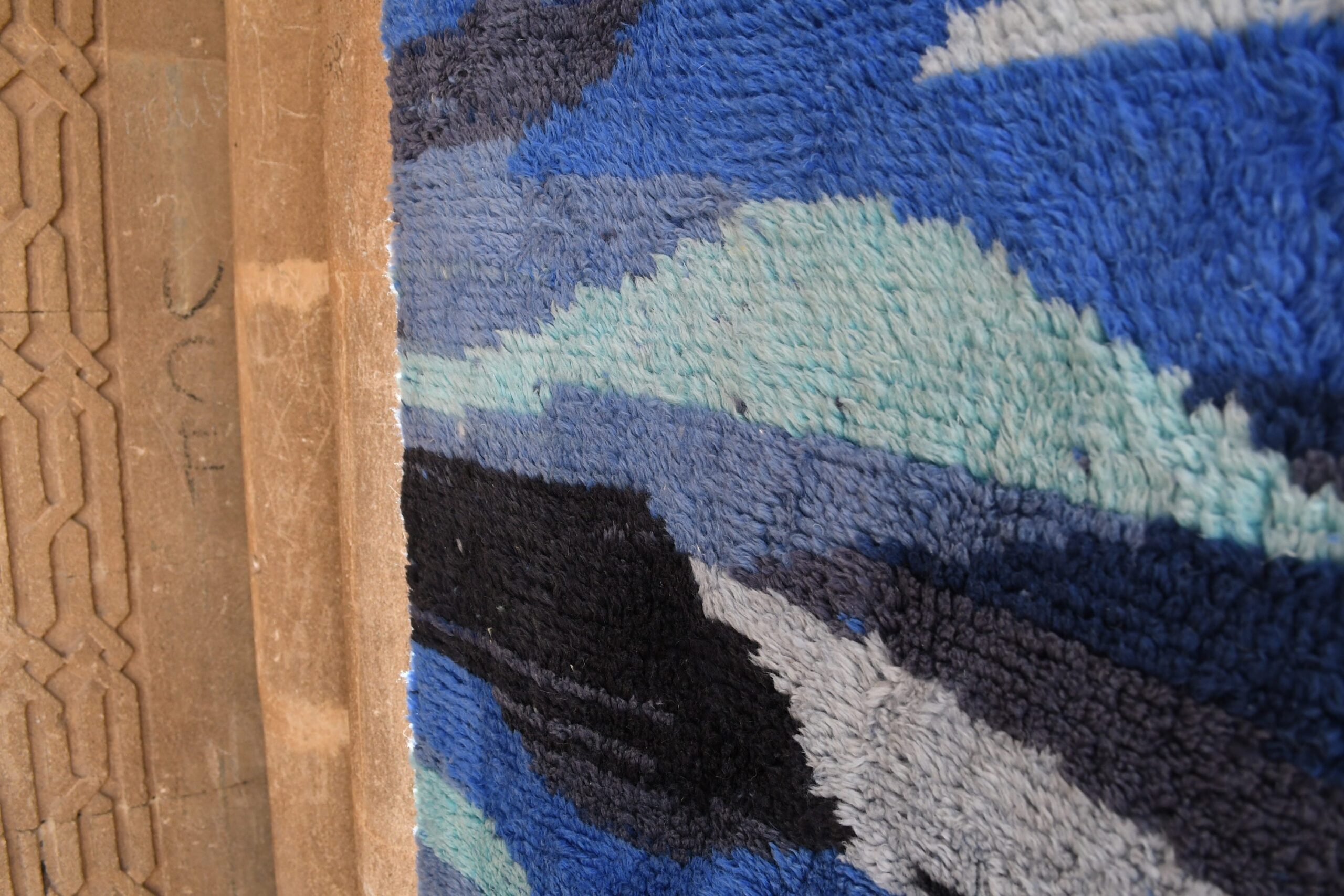 a blue rug with a wooden frame. il_fullxfull.6083093361_62mk.jpg