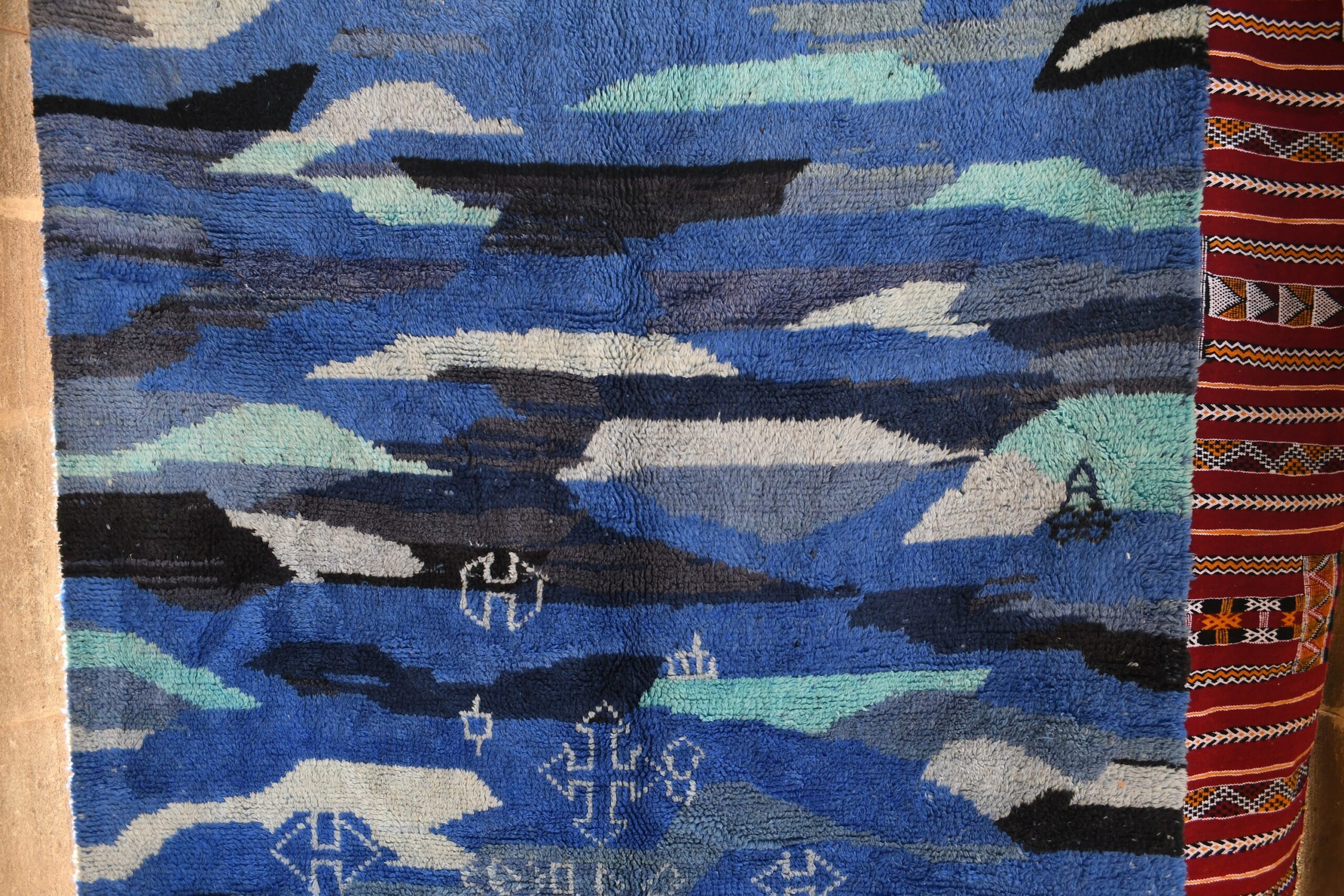 a blue rug with a pattern of clouds. il_fullxfull.6083093539_iyyl.jpg