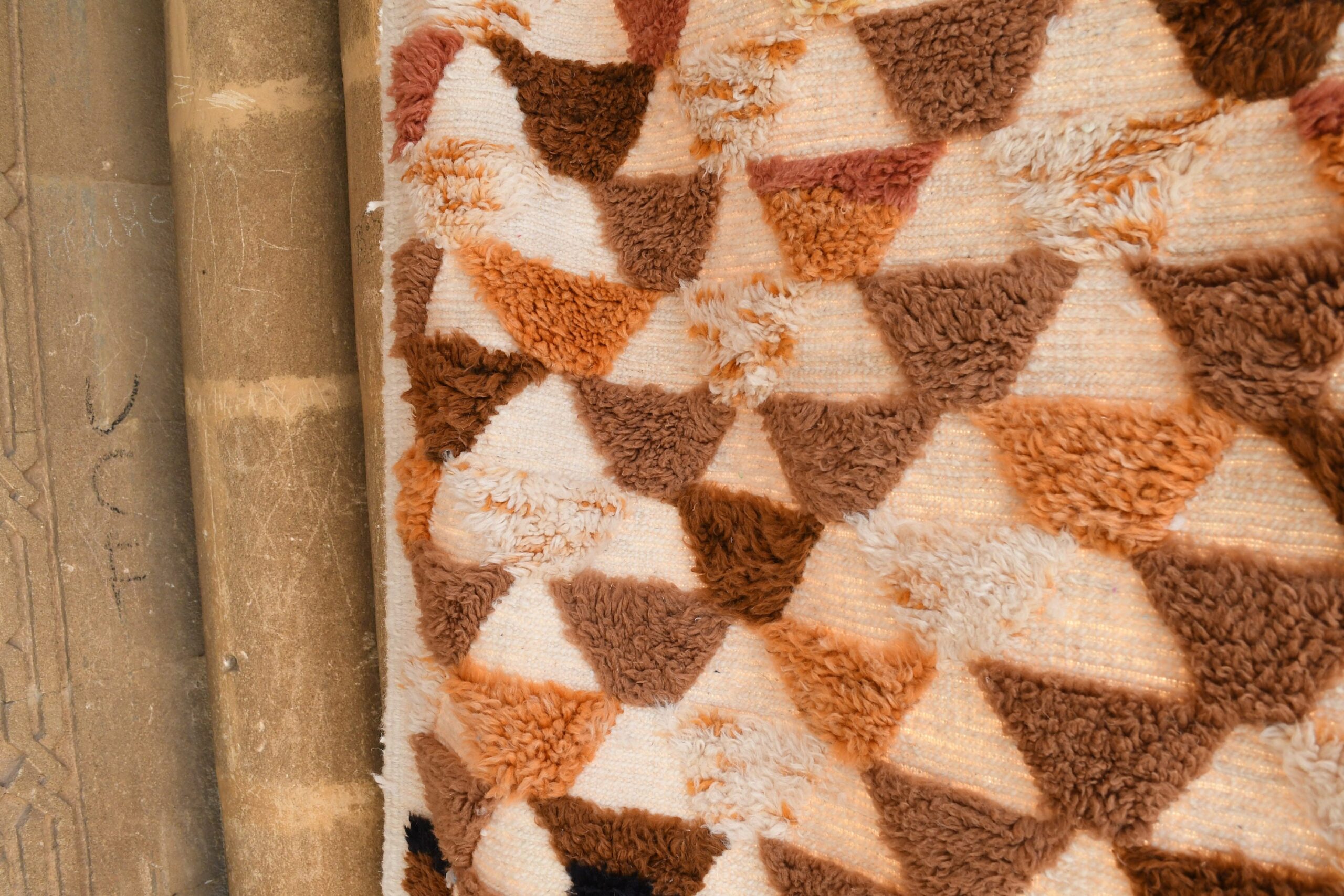 a cat is sitting on a moroccan rug on a wooden floor. il_fullxfull.6083103271_jm4g.jpg