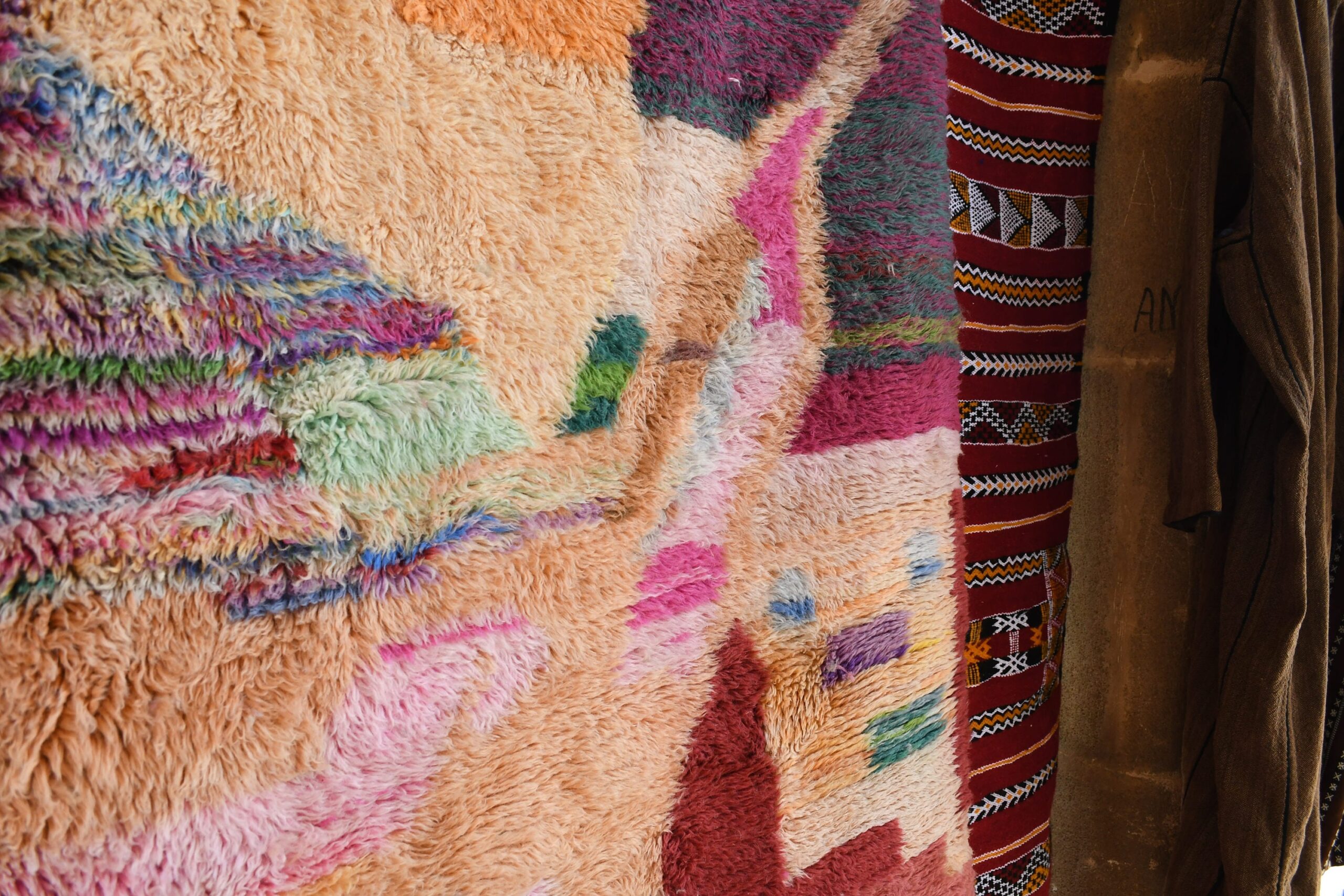 a woman is standing next to a colorful rug. il_fullxfull.6083104903_72b9.jpg