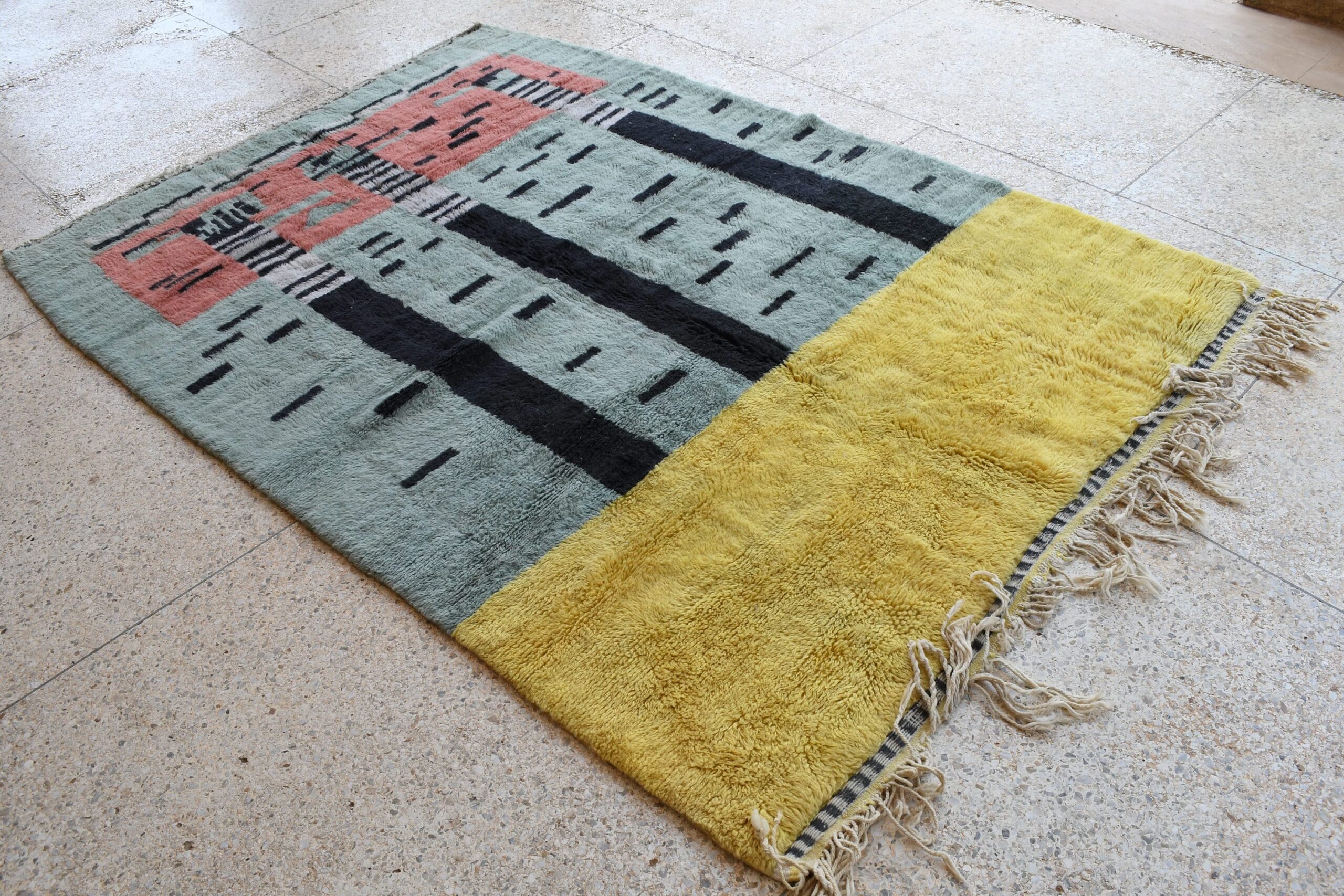 a rug with a yellow and black design. il_fullxfull.6083116245_ha5j.jpg