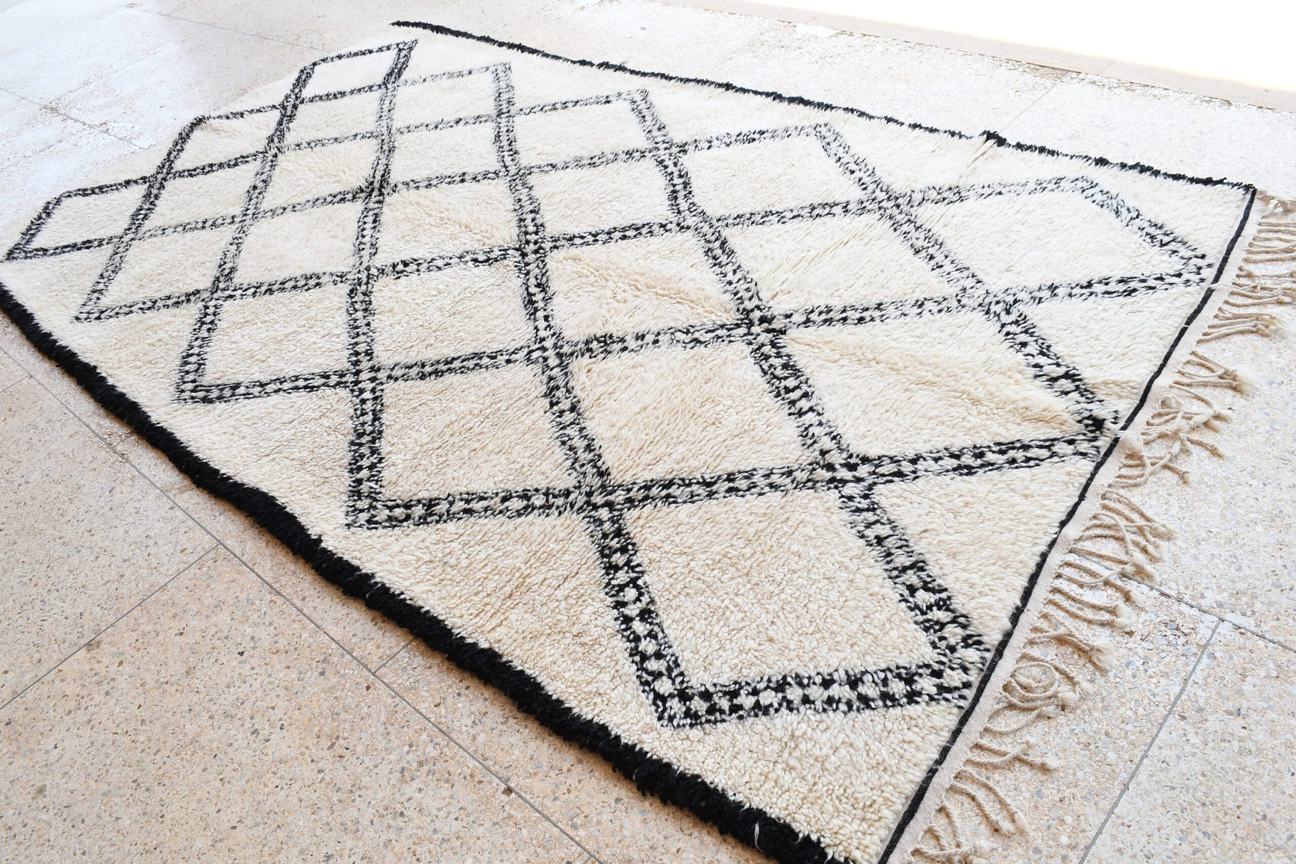 a black and white rug with a diamond pattern. il_fullxfull.6083120409_iybi.jpg