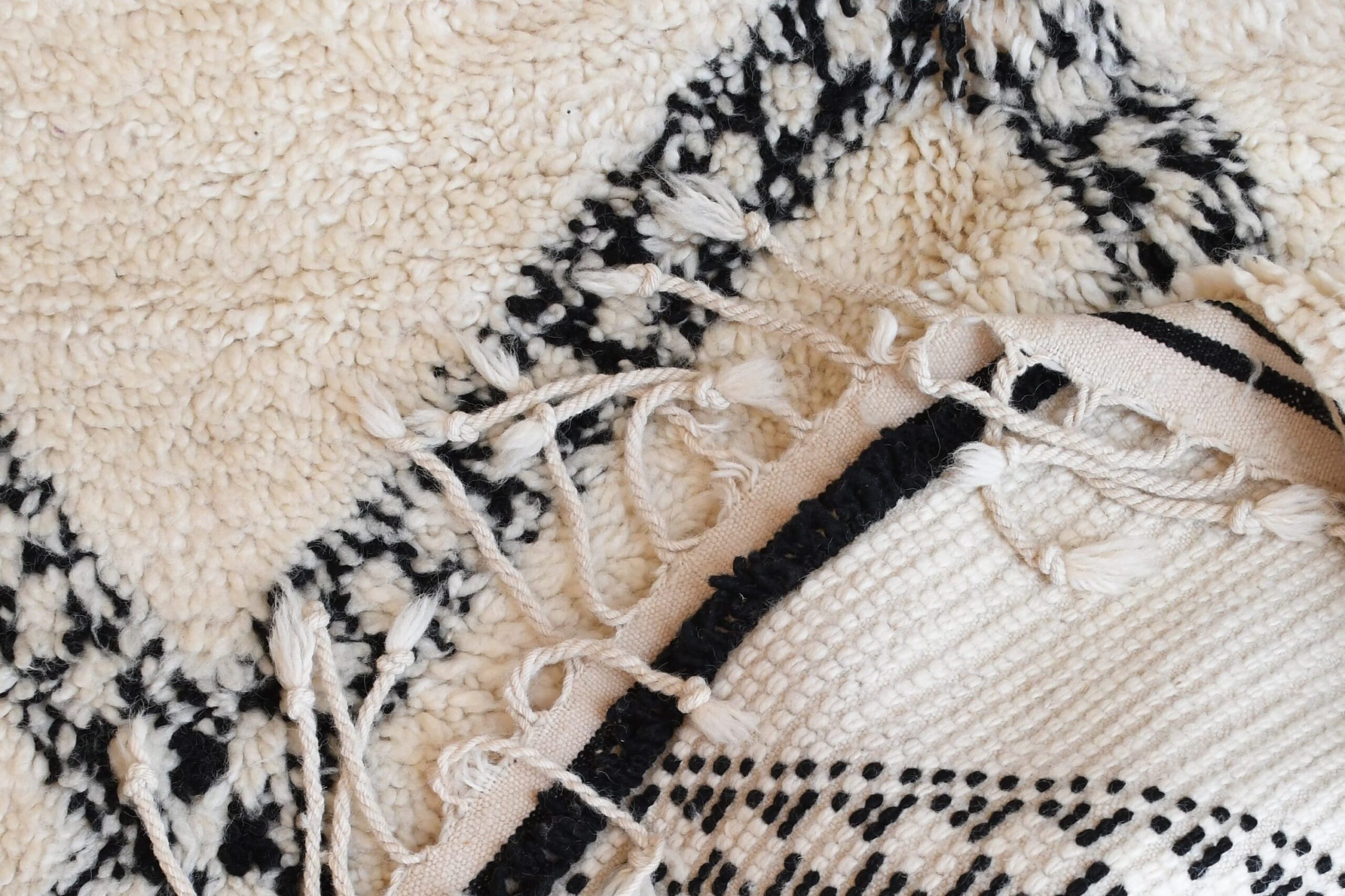 a black and white rug with fringes. il_fullxfull.6083120541_2k6d.jpg