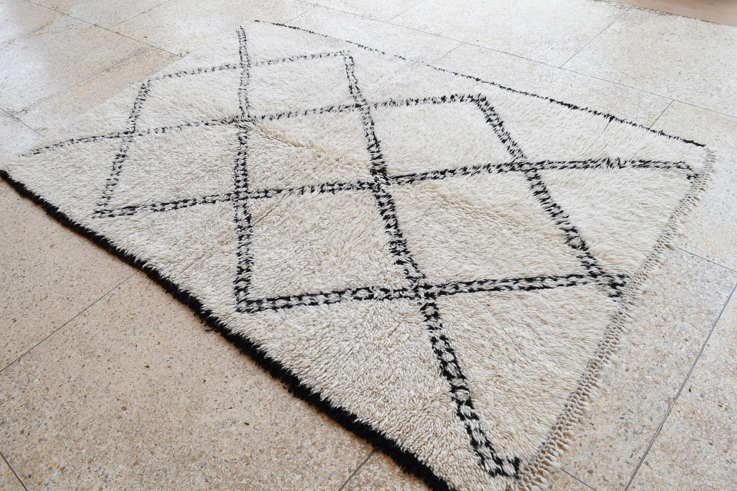 a rug with a black and white design. il_fullxfull.6083123231_ld8f.jpg