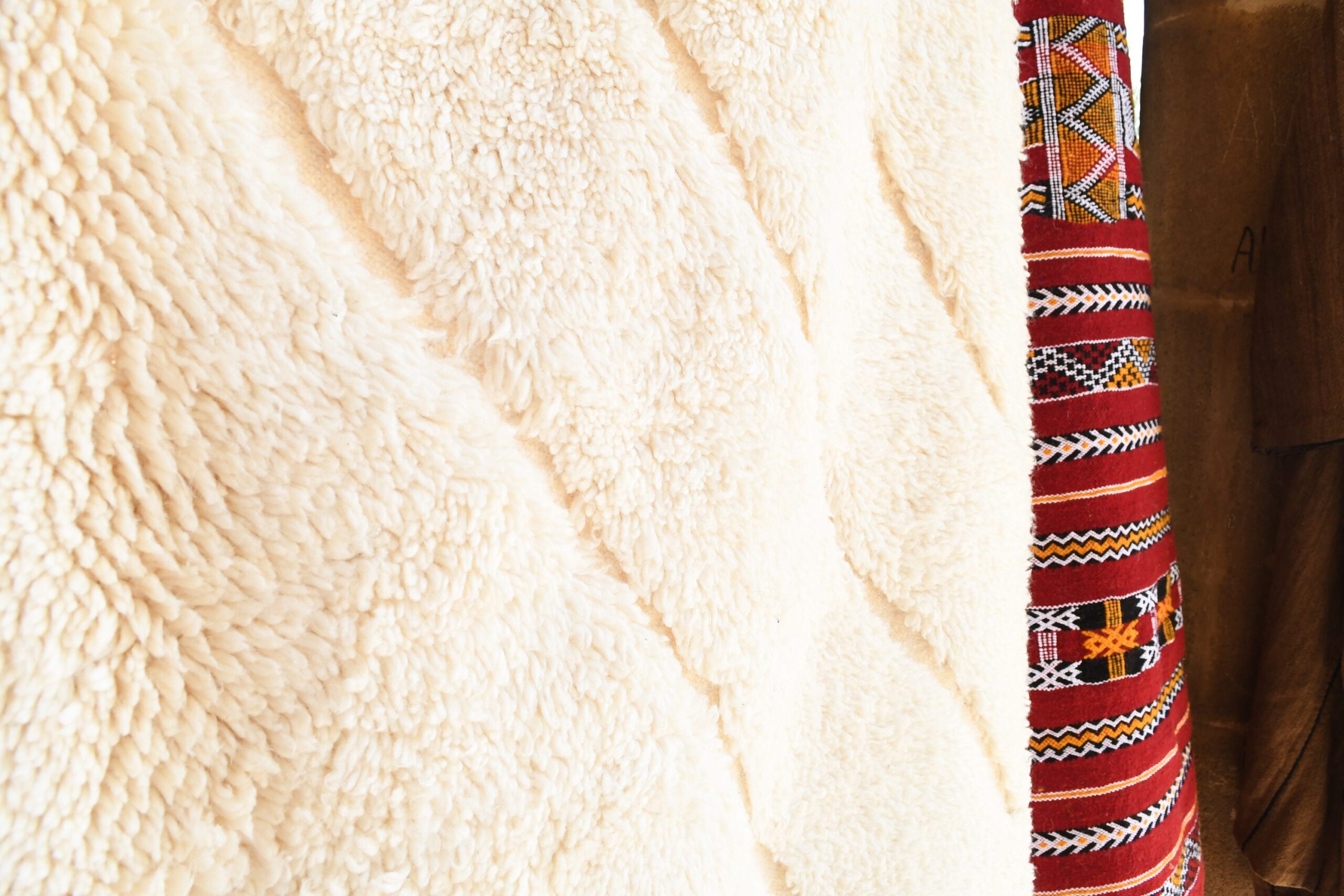 a woman wearing a white coat and a red moroccan rug. il_fullxfull.6083125743_jdjr.jpg