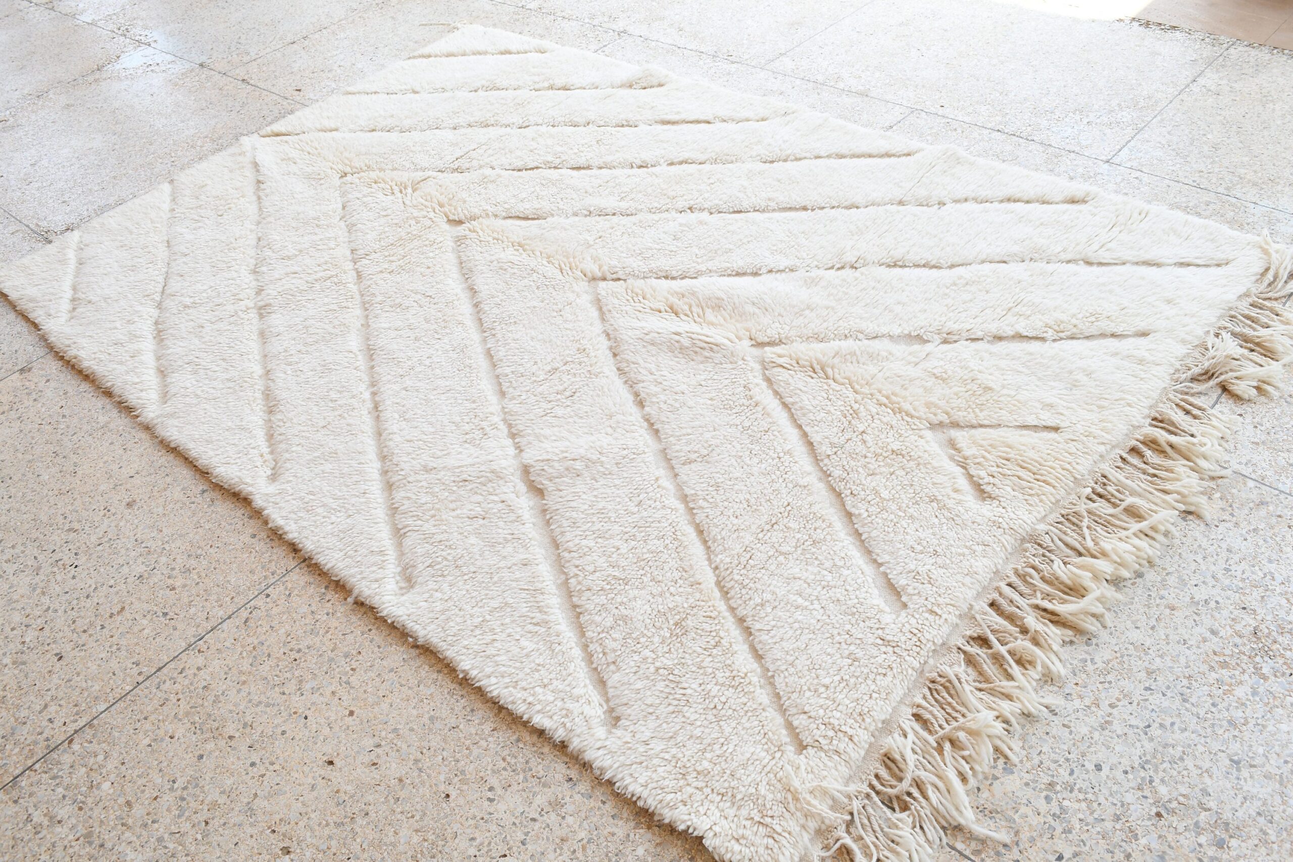 a white rug with fringes on the floor. il_fullxfull.6083126227_coyv.jpg