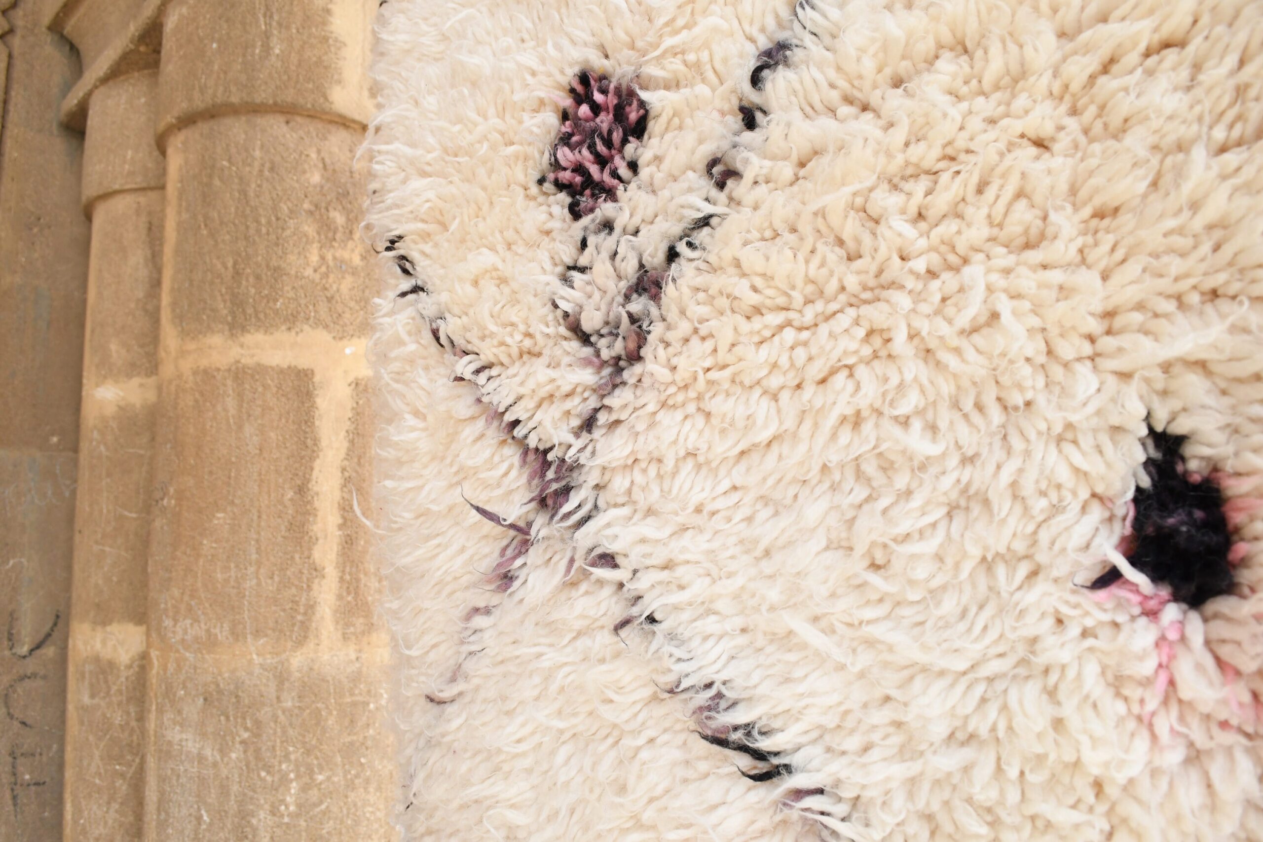 a sheep is standing in a barn with a brick wall. il_fullxfull.6083148925_gecj.jpg